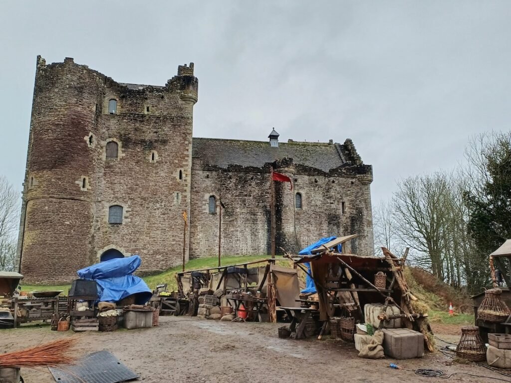 Doune Castle with Outlander filming props outside on our Outlander day tour from Edinburgh