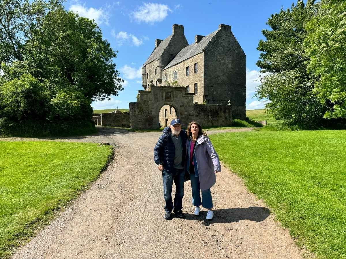 Two Clients posing for a photo outside Lallybroch