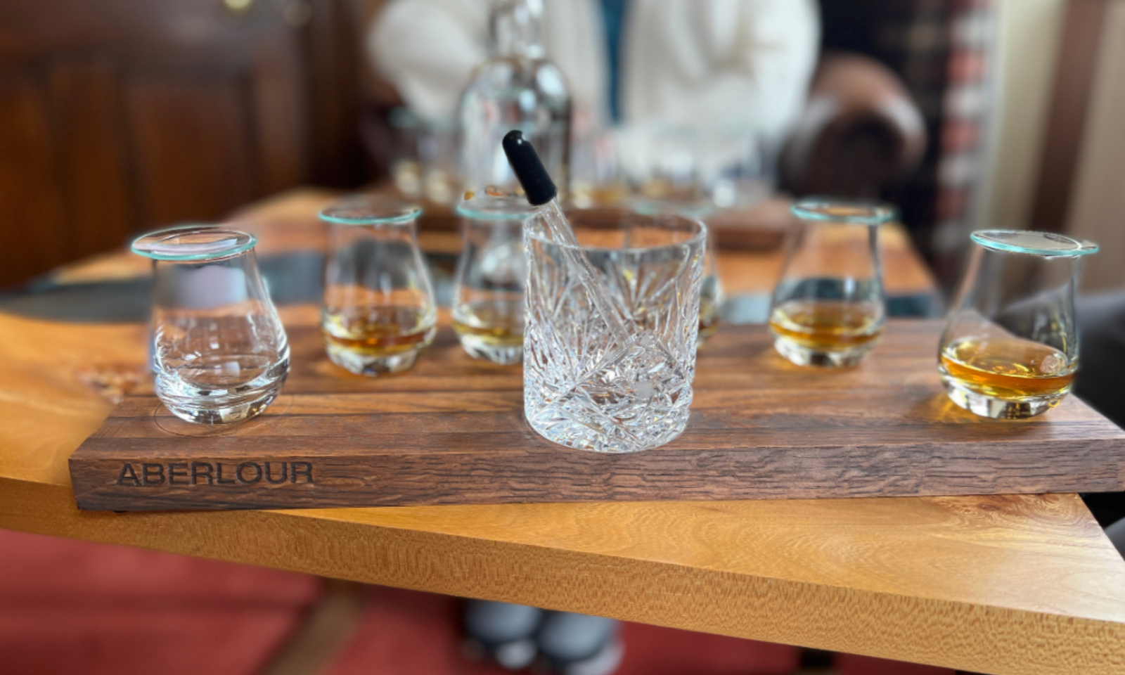 Aberlour whisky tasting flight on an engraved wooden board, Speyside