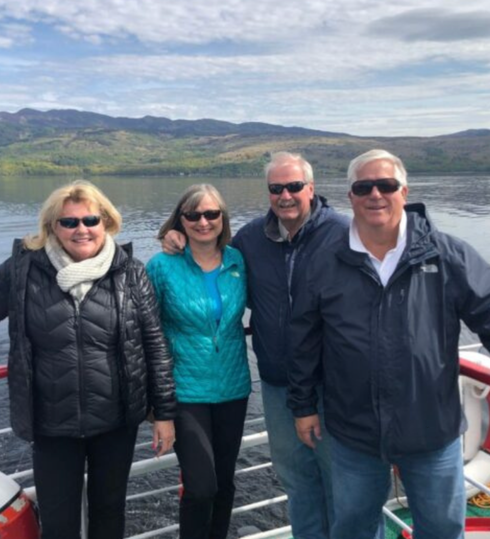 Guests enjoying a tour by boat in Scotland Smiling guests on a boat trip during a private Scotland tour