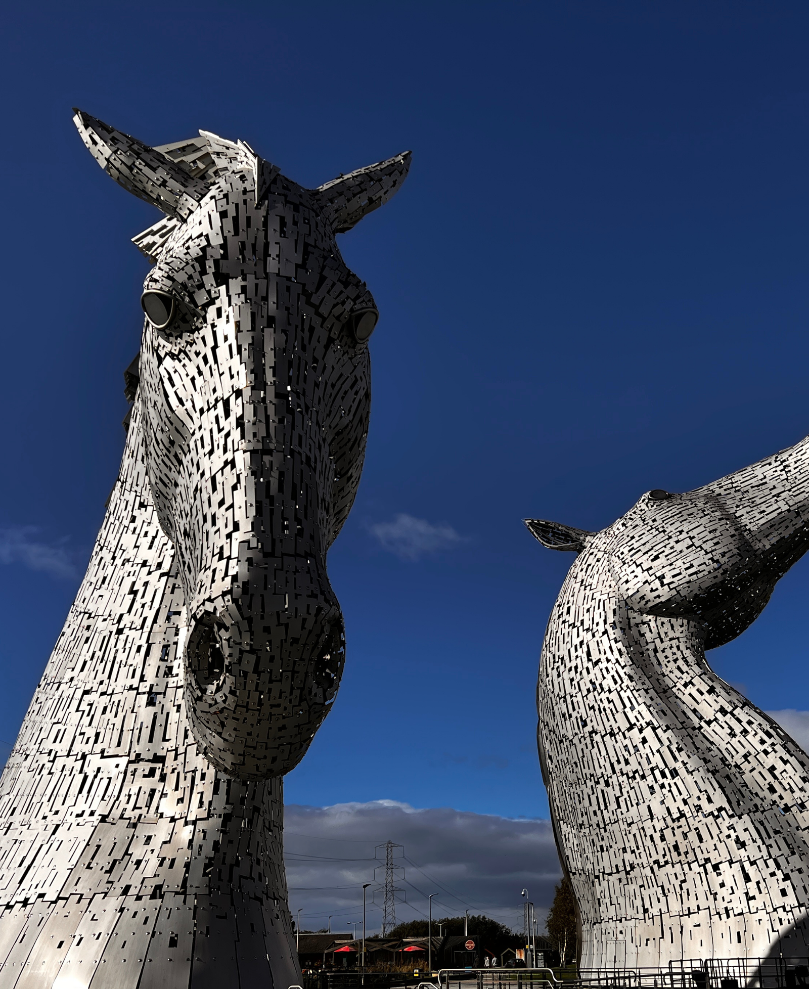 The Kelpies The Kelpies, giant steel horse-head sculptures in Falkirk, Scotland, viewed from below against a blue sky