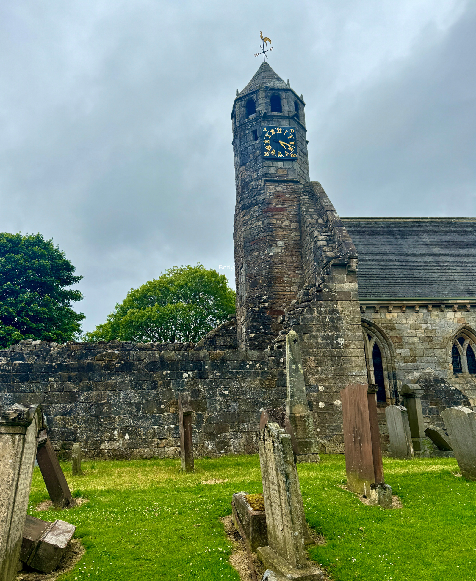 St Brides Church Douglas St Bride's Church clock tower and ruined walls in Douglas, with weathered gravestones in the foreground