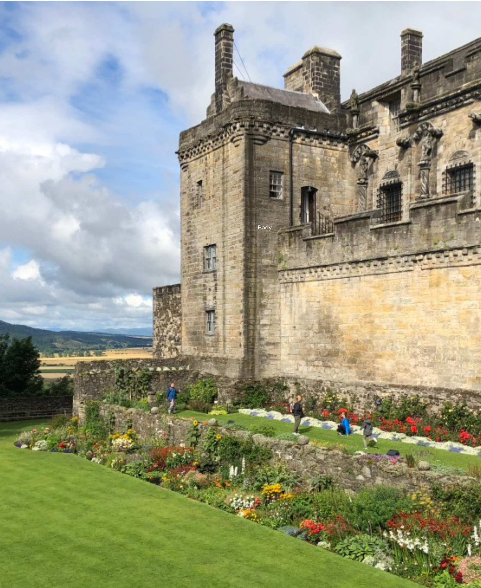 Stirling Castle Stirling Castle in Scotland, with visitors walking through terraced gardens and countryside views in the background