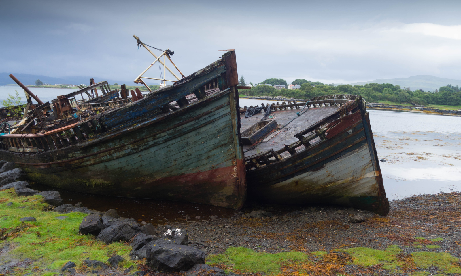 Abandoned Fishing Boat Wrecks, Isle of Mull Weathered wooden shipwrecks beached on the shore, Isle of Mull, Scotland