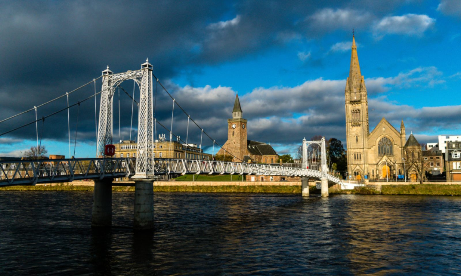 Greig Street Bridge Over the River Ness, Inverness Suspension footbridge over the River Ness with Inverness spires behind
